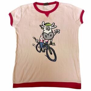 Mad's pink cotton baby tee with cartoon cow riding a bicycle graphic